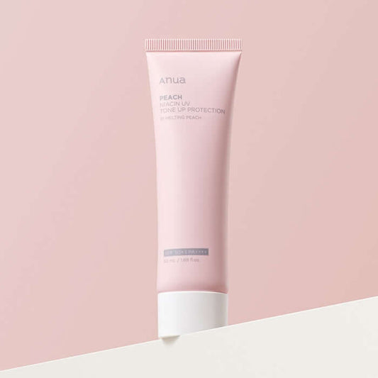 Anua Peach Niacin UV Tone Up Protection 01 Melting Peach sunscreen tube on a minimalist background.