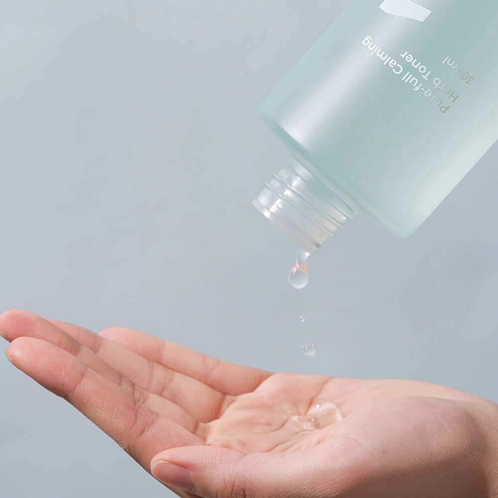 Numbuzin No.1 Pure-full Calming Herb Toner 300ml being poured into a hand, showcasing its soothing properties.
