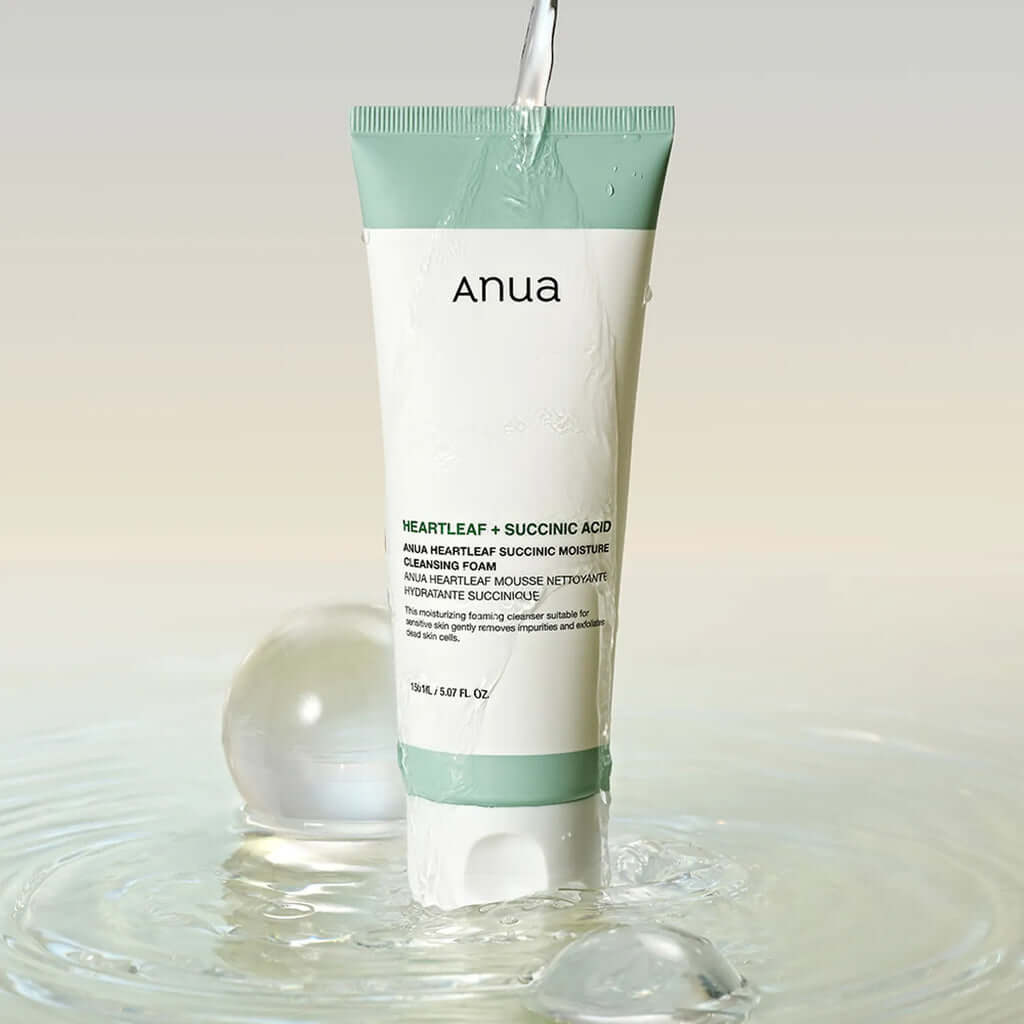 Anua Heartleaf Succinic Moisture Cleansing Foam tube in water, ideal for sensitive acne-prone skin with exfoliating benefits.