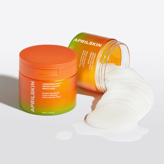 APRILSKIN Carrotene IPMP Instant Calming Serum Pads in jar with pads spilling out, vegan skin smoothing treatment.