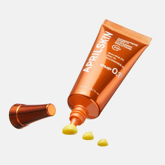 APRILSKIN Carrotene IPMP Clearing Solution tube with product oozing out, vegan acne treatment, 2% BHA PHA.