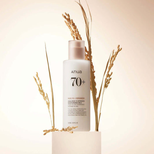 ANUA Rice 70 Intensive Moisturizing Milk in a minimalist setting with rice stalks for hydration and brightening.