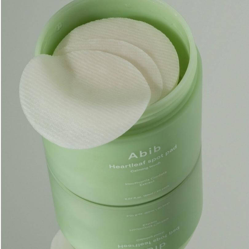 Abib Heartleaf Spot Pad Calming Touch with toner pads for soothing irritated skin in a green container.
