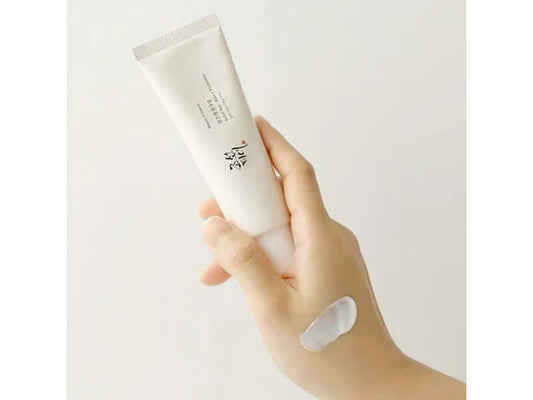 Beauty of Joseon RELIEF SUN : RICE + PROBIOTICS (SPF50+ PA++++), creamy sunscreen in hand with product on skin.