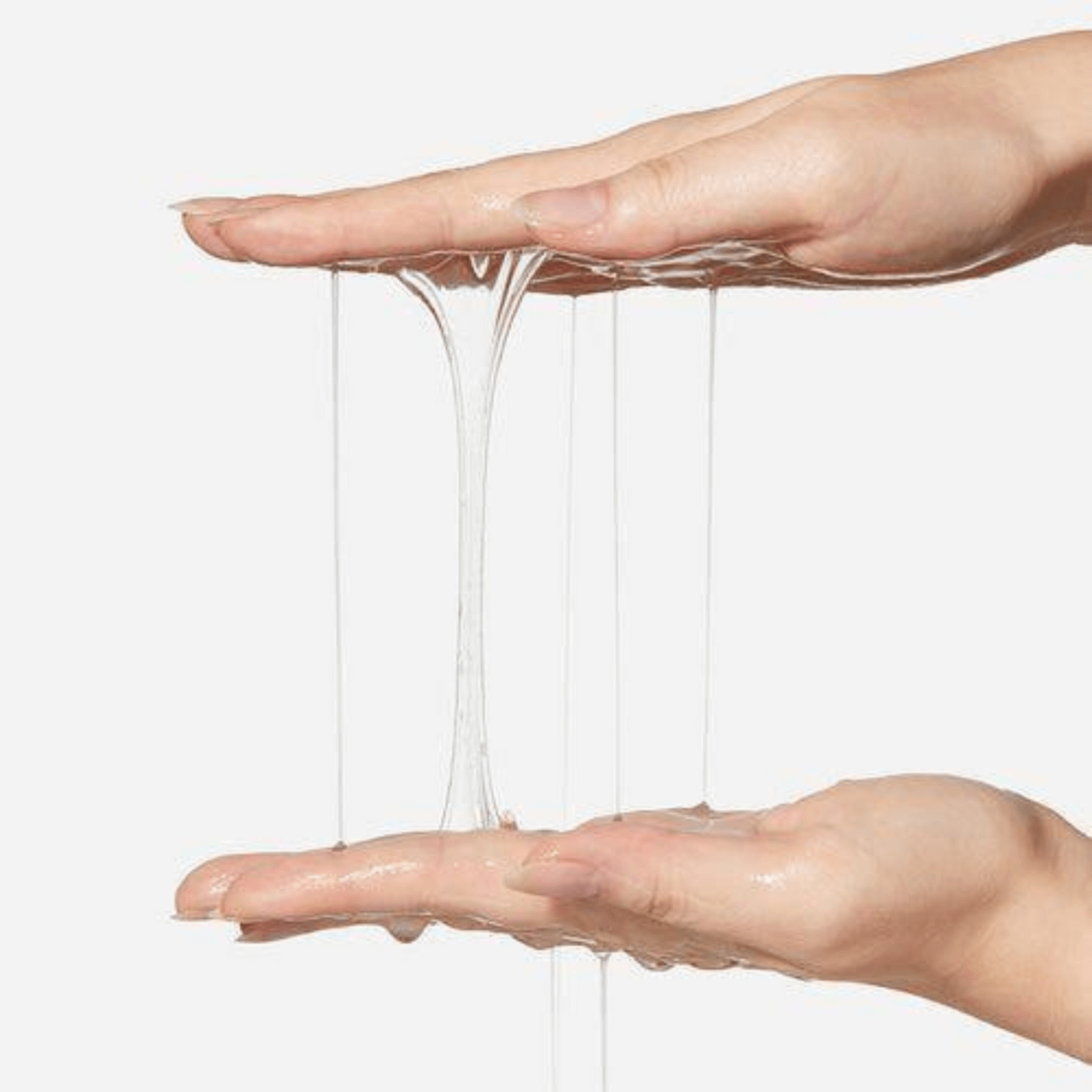 Hands showcasing the viscous texture of APRILSKIN Pink Aloe Mucin Serum, highlighting its hydrating properties.