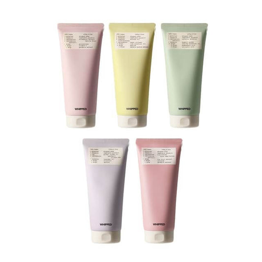 Pack of WHIPPED Vegan Cleanser tubes in various colors, showcasing natural ingredients for skin nourishment.
