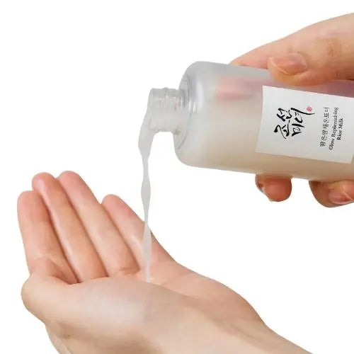 Beauty of Joseon Glow Replenishing Rice Milk being poured into a hand, showcasing its hydrating formula.