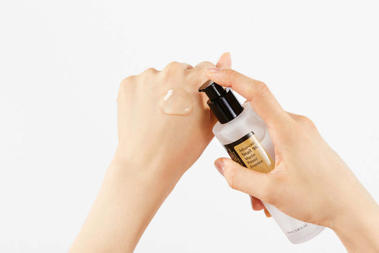 COSRX Advanced Snail 96 Mucin Power Essence being dispensed on a hand for hydrating skincare.