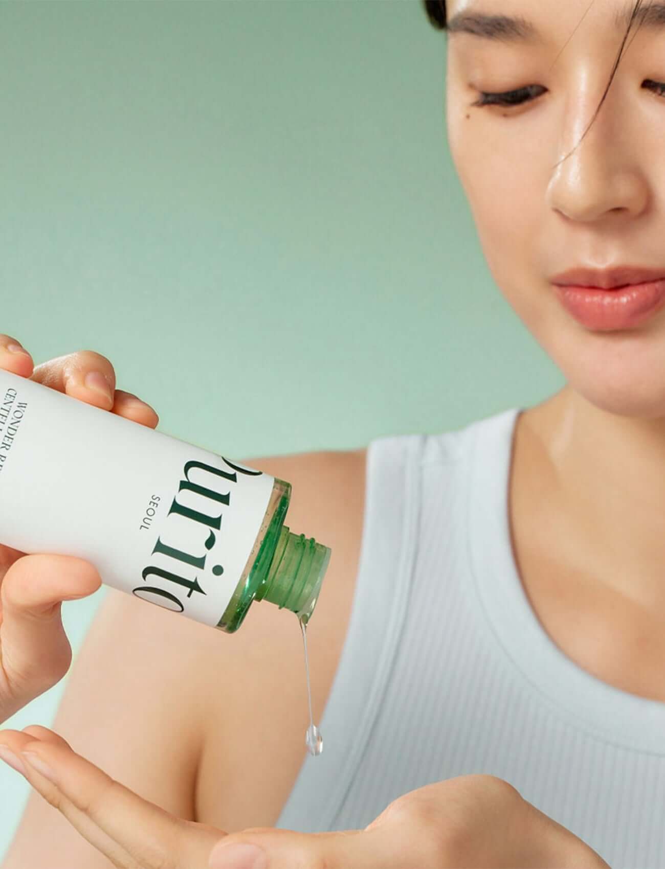Woman applying Purito Seoul Wonder Releaf Centella Toner, showcasing hydration and skin-friendly ingredients.
