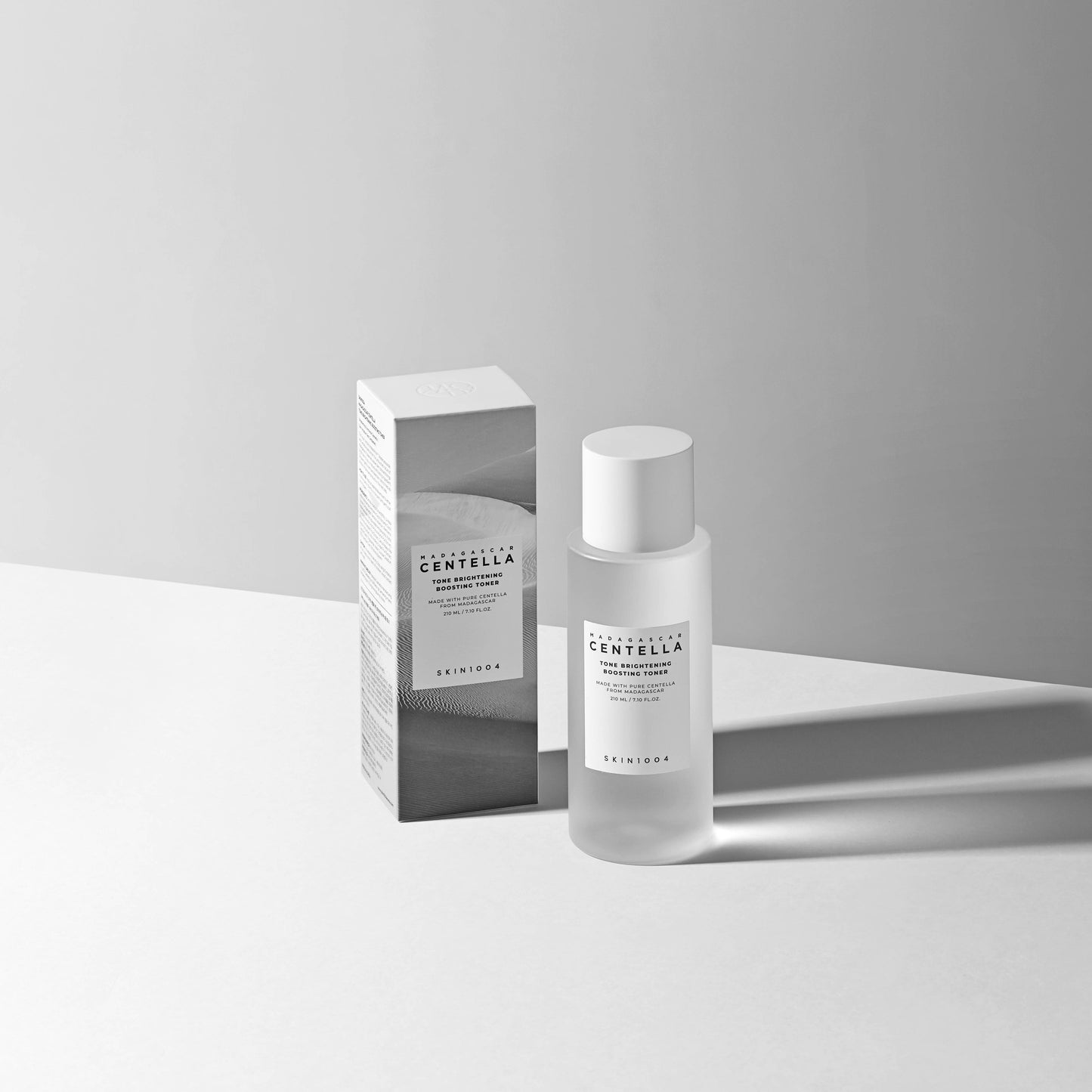 Skin1004 Madagascar Centella Tone Brightening Boosting Toner 210ml with box on a minimalist background.