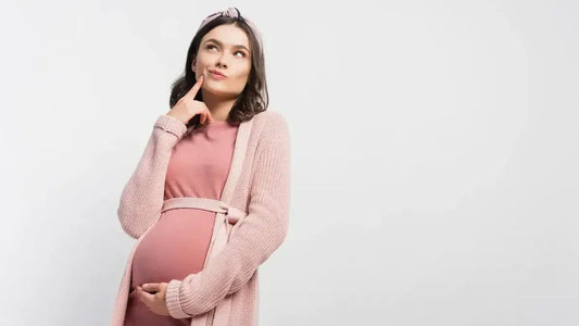 Pregnant woman in comfortable outfit thinking about K-beauty ingredients during pregnancy.