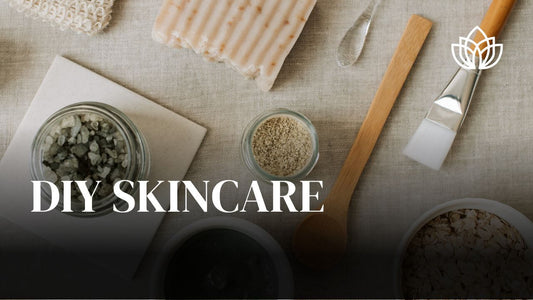 A flat lay of DIY skincare ingredients including jars, tools, and natural materials on a textured surface.