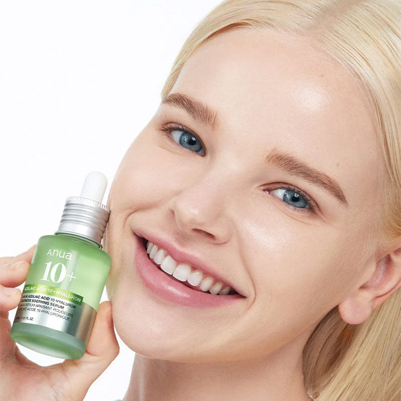 ANUA Azelaic Acid 10 Hyaluron Redness Soothing Serum held by a smiling model showcasing its soothing properties.
